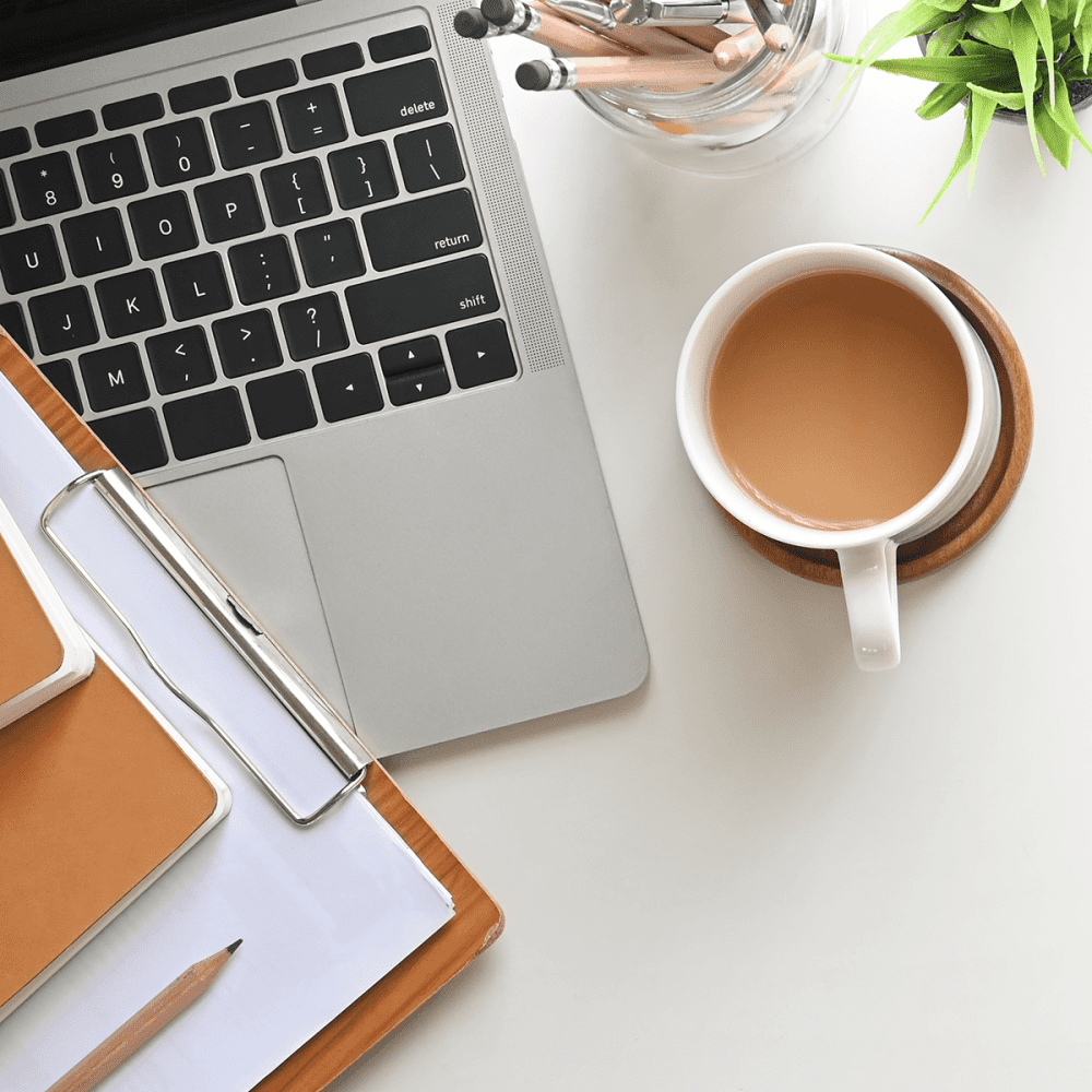 Coffee laptop and notes on desk